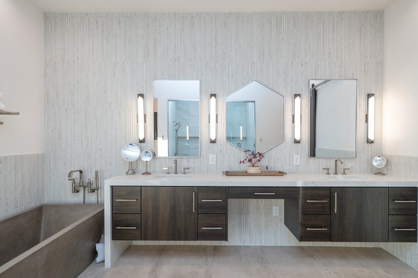 Fluted stone tile with floating wood vanities