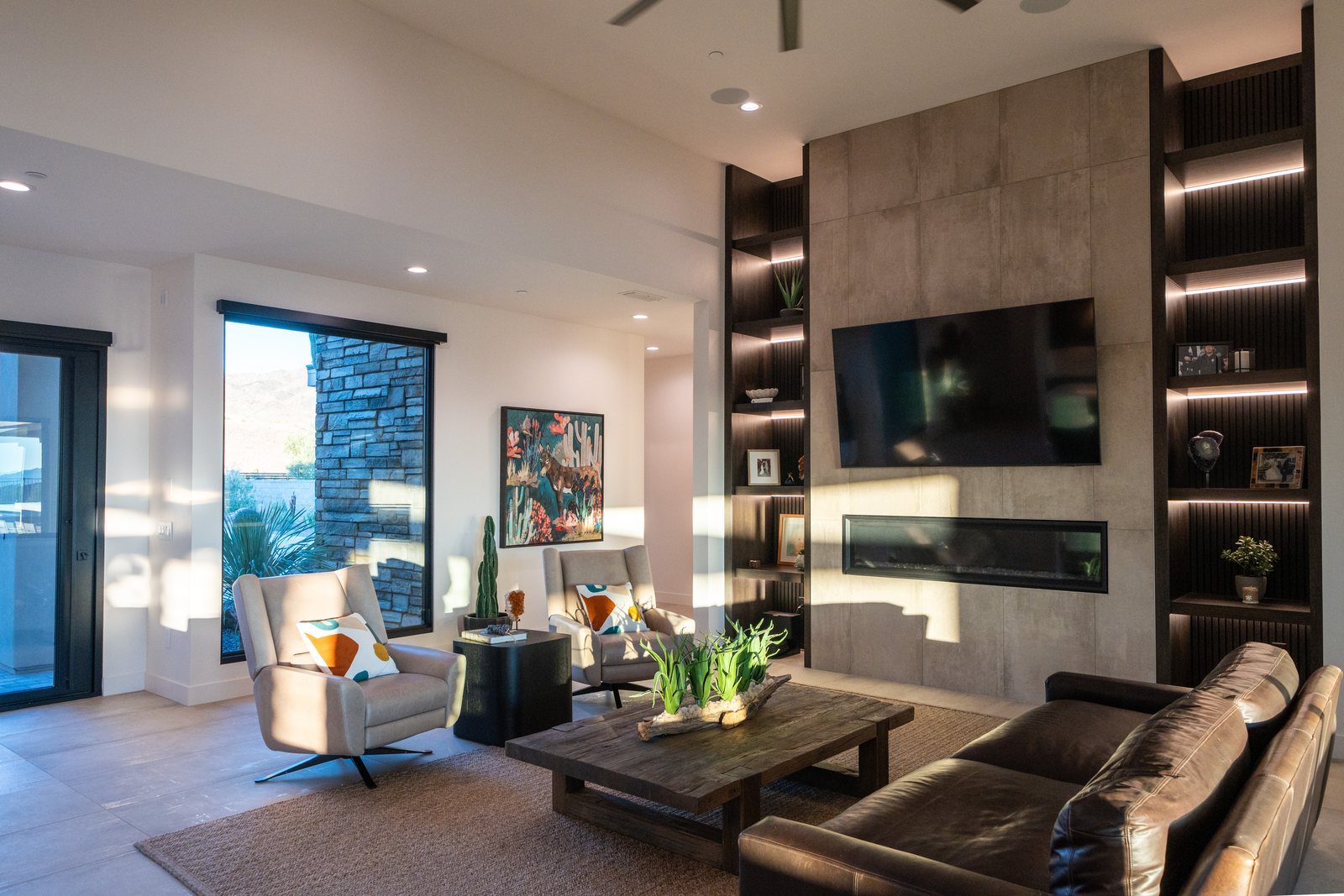 Floor-to-ceiling dark wood built-ins flanking a concrete fireplace, with integrated LED-lit reveals