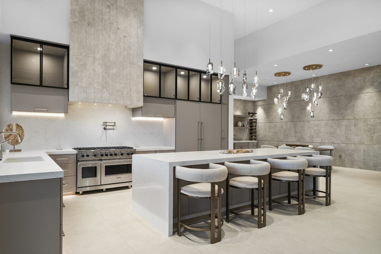 Custom kitchen with a marble waterfall island