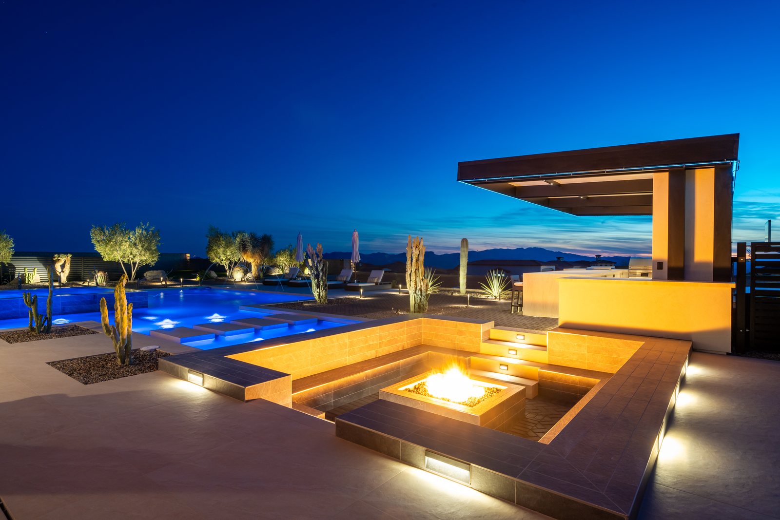 Sunken fire pit lounge and pool at twilight