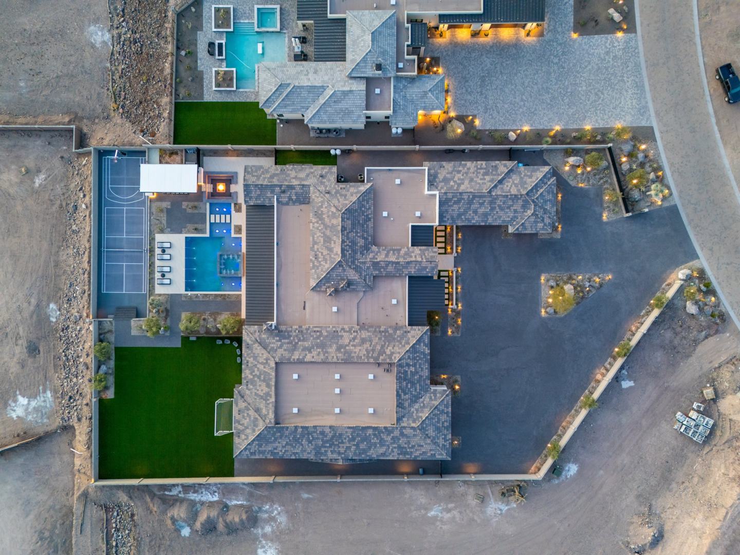Top-down aerial of the estate showing pool, sport court, and lawn