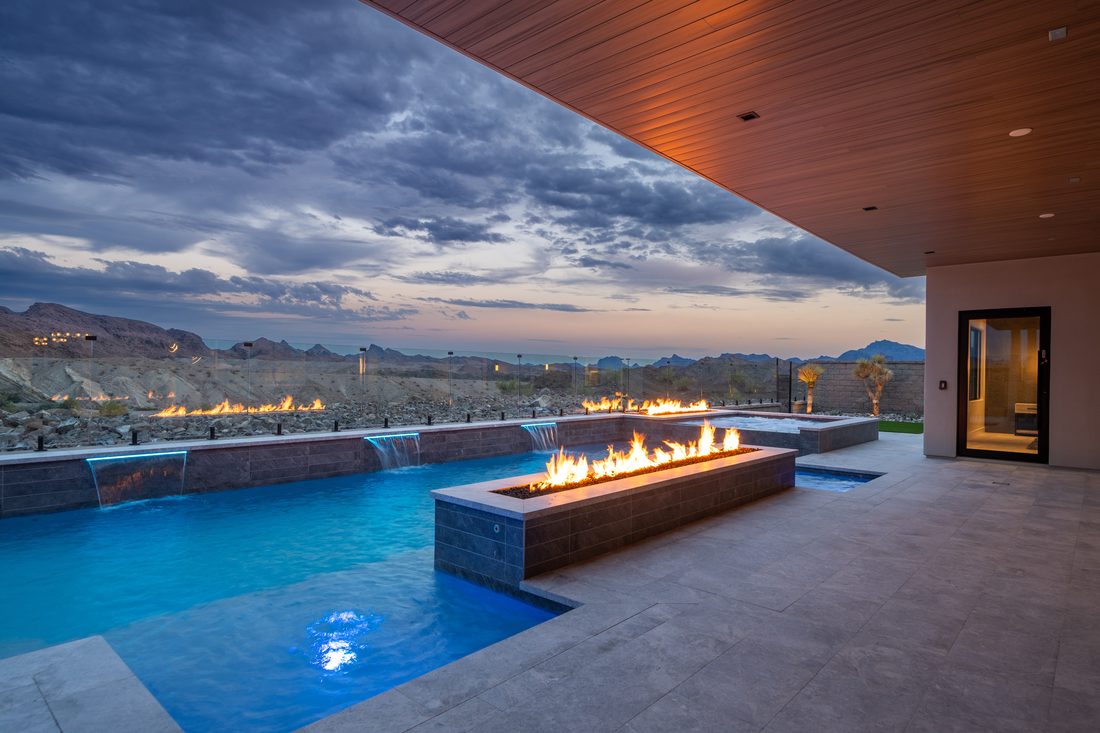 Flat Irons pool with fire features at dusk