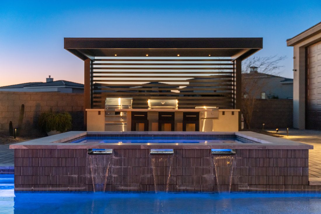 Flat Irons pool with outdoor kitchen and pergola
