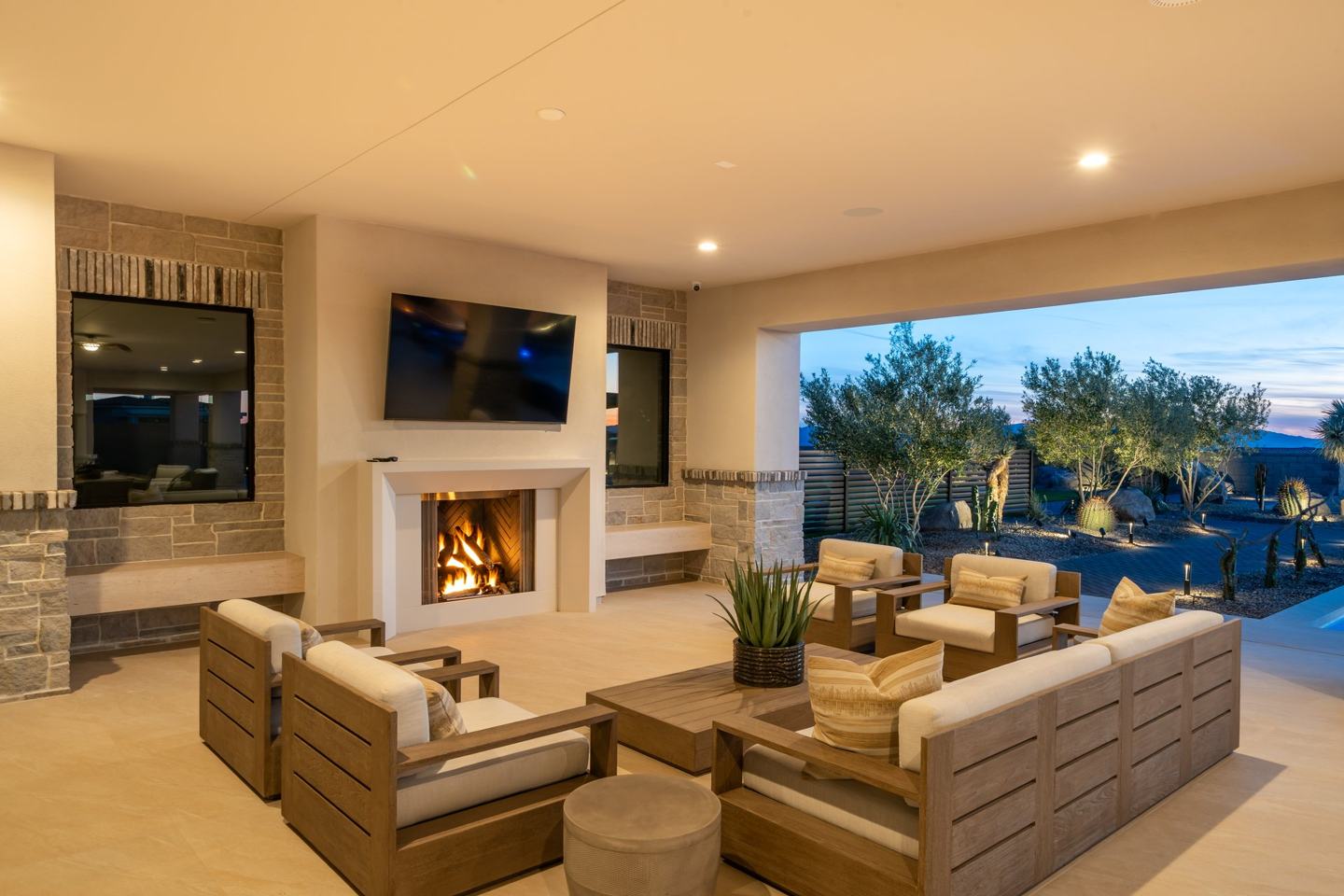 Covered patio lounge with an outdoor fireplace