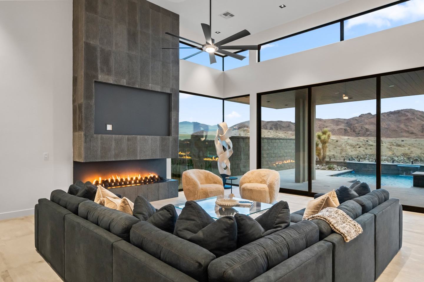 Great room with a linear fireplace and glass walls