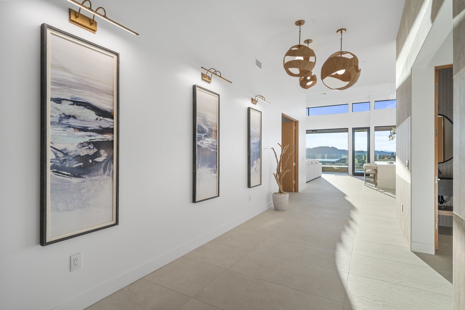 Gallery hallway with woven pendants and framed art
