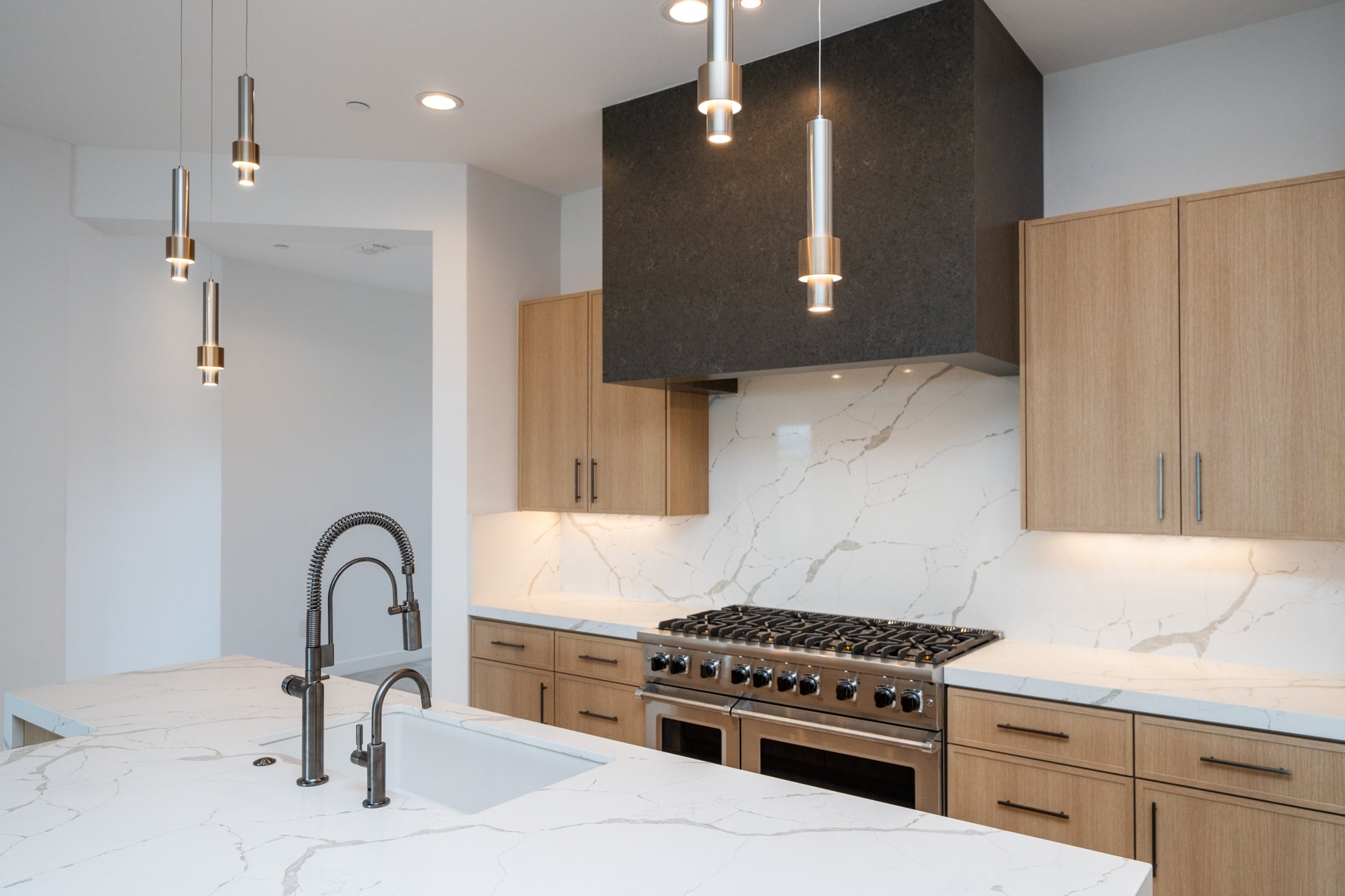 Chef kitchen with a pro range and brass pot filler
