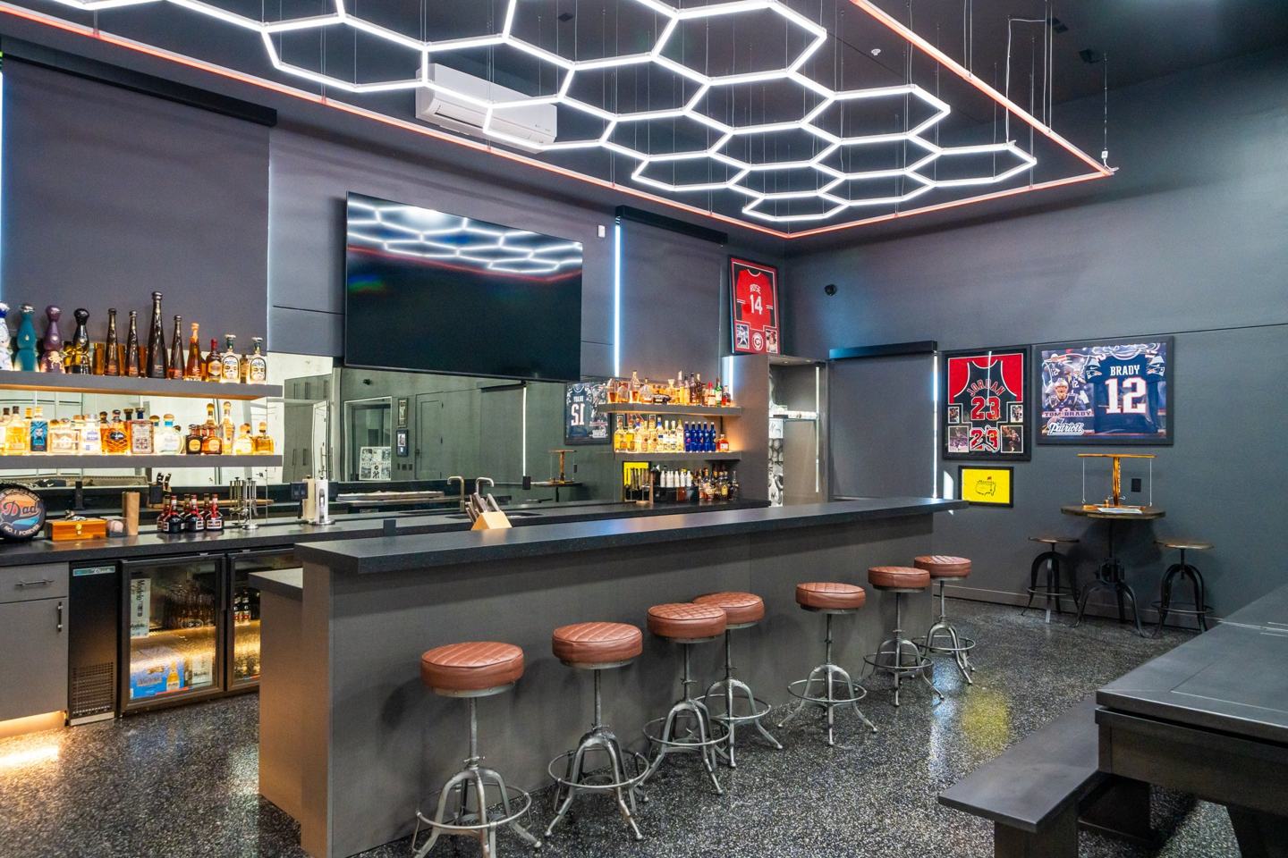 Home sports bar with backlit spirit shelving