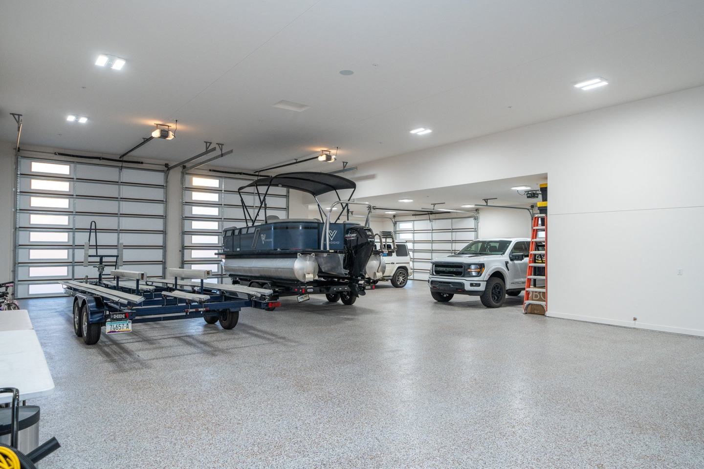 Oversized garage with boat storage, multiple bays, and epoxy floors