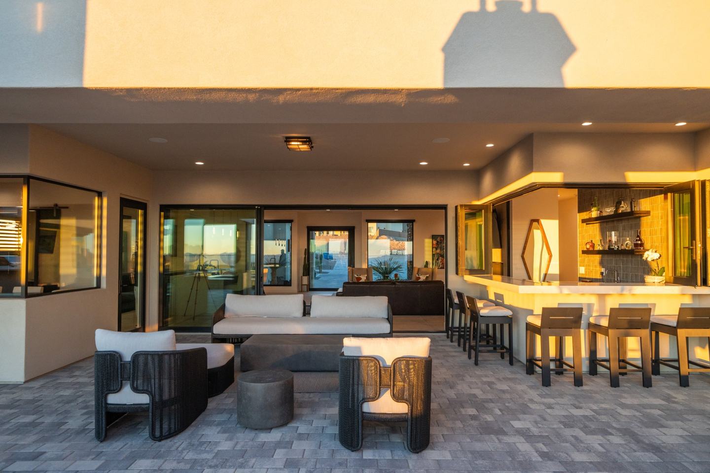 Patio lounge with pass-through bar seating in golden hour light