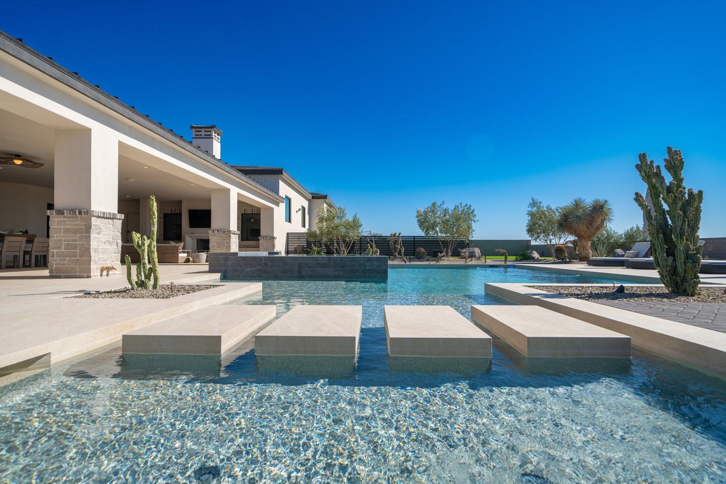 Resort pool with floating stone step pads