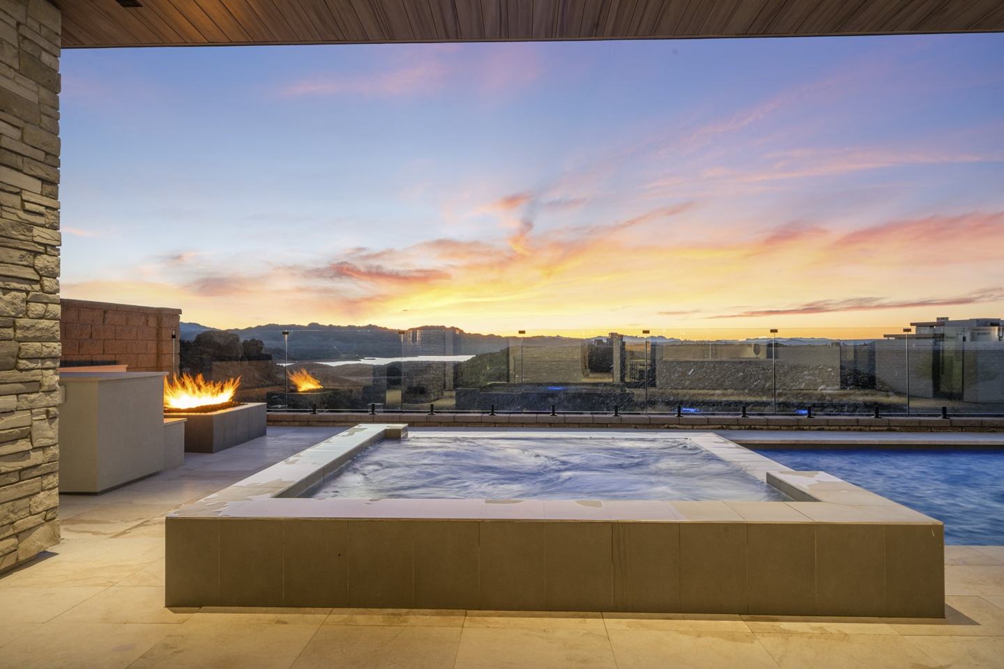 Raised spa with fire features over a desert sunset