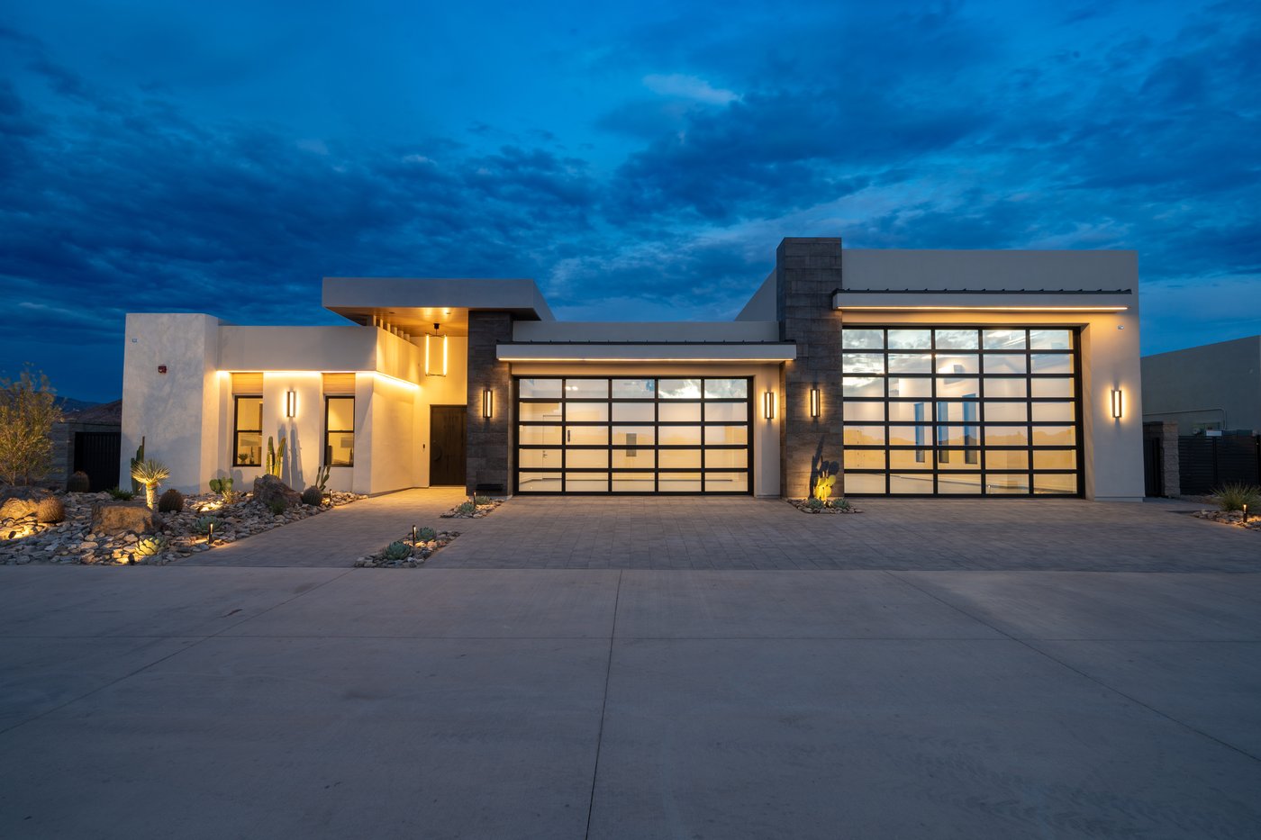 Janecek custom home, glass garage facade at blue hour
