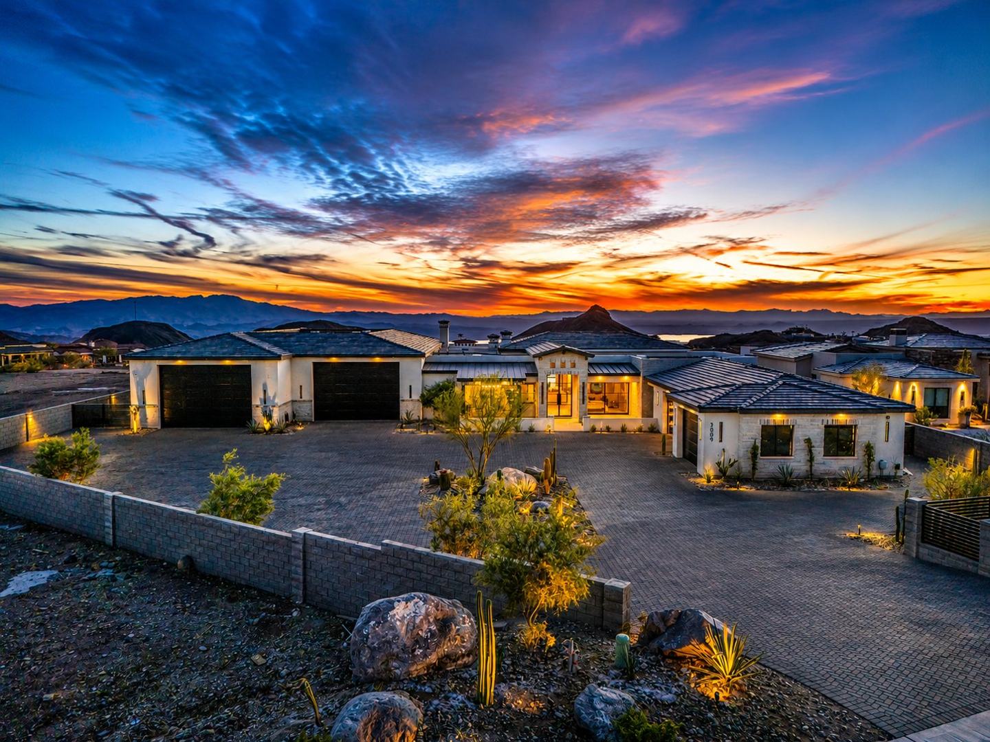 A Janecek home at sunset above Lake Havasu with a dramatic colored sky
