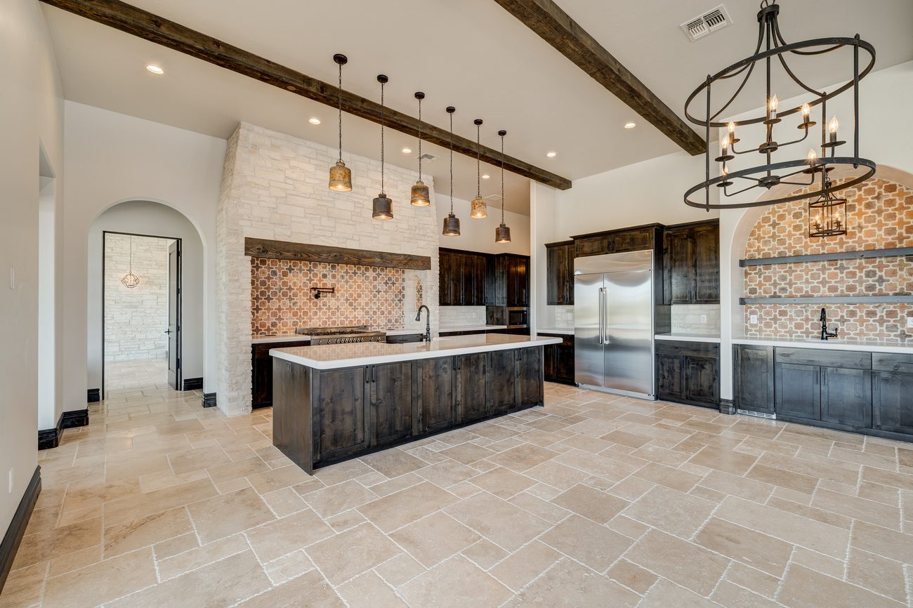 Kitchen with stone hood and handmade terracotta backsplash