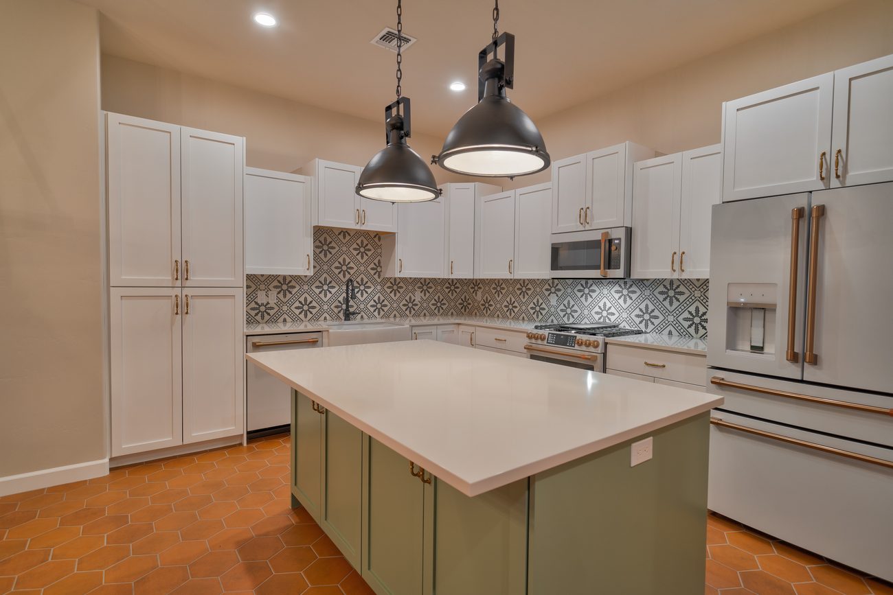 Custom kitchen with island and terracotta tile floor